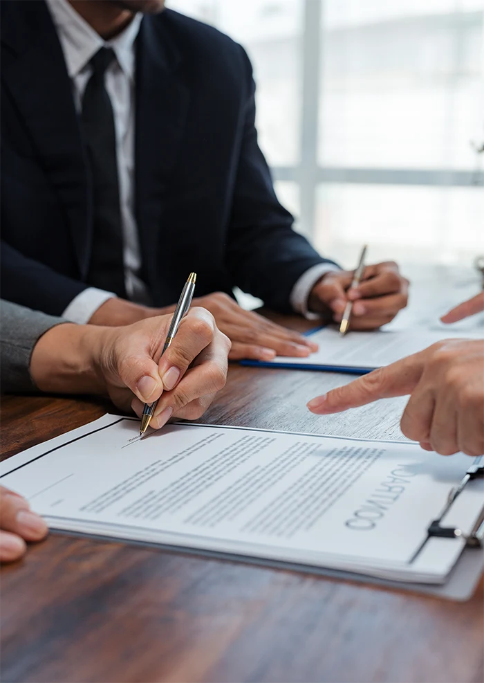 Attorney reviewing and signing planning documents with clients